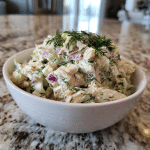 Dill chicken salad with Greek yogurt served with fresh dill.